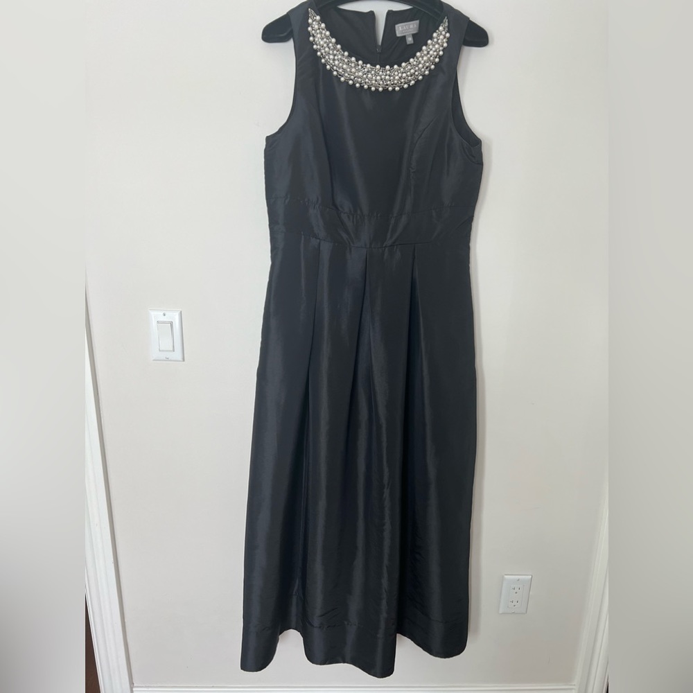 Sleeveless black dress with beaded detail at neckline